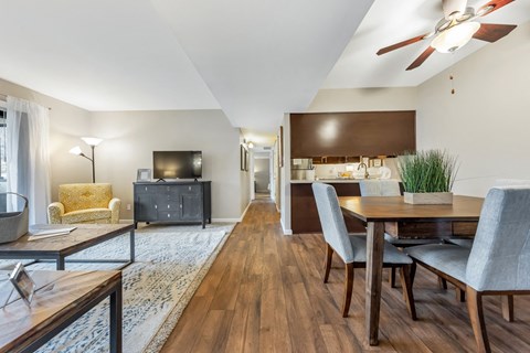 a living room with a dining room table and a tv
